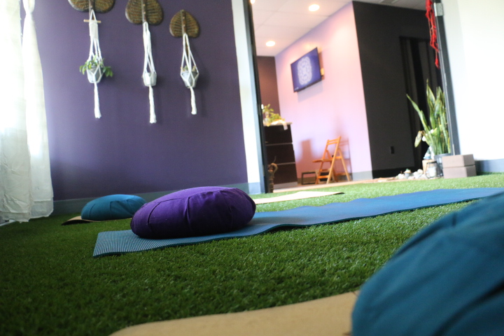A quiet restorative yoga setup with props for private healing practice
